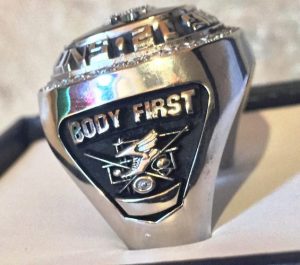 Side view of a silver Big 12 Rings Body First has earned. 
