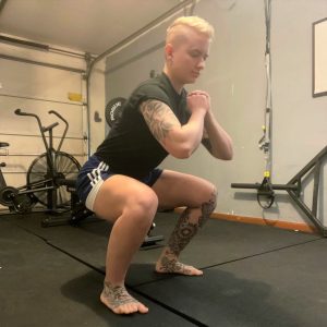 Picture of Personal trainer, Annie doing a bodyweight squat